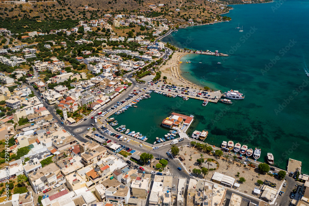 ELOUNDA, CRETE, GREECE - JULY 16 2019: Aerial view of the popular high-end tourist town of Elounda on the Greek island of Crete in the Aegean Sea.