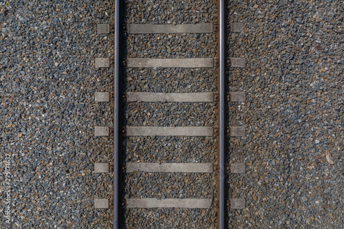 railway rails with sleepers on gravel close-up top view