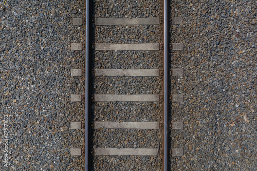 Bild auf Leinwand railway rails with sleepers on gravel close-up top view
