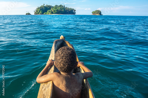 The little boy in wooden canoe