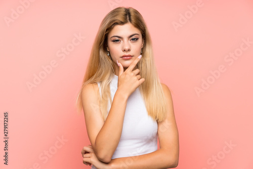 Teenager girl over isolated pink background thinking an idea