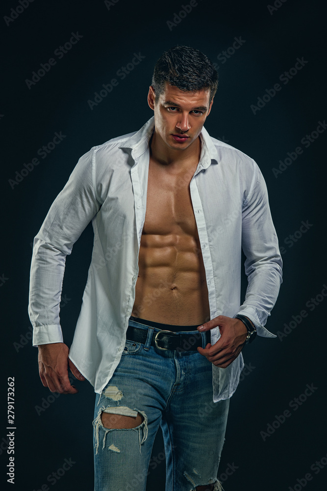Muscular Men in Jeans Wearing Shirt Exposing his Muscular Build Stock ...
