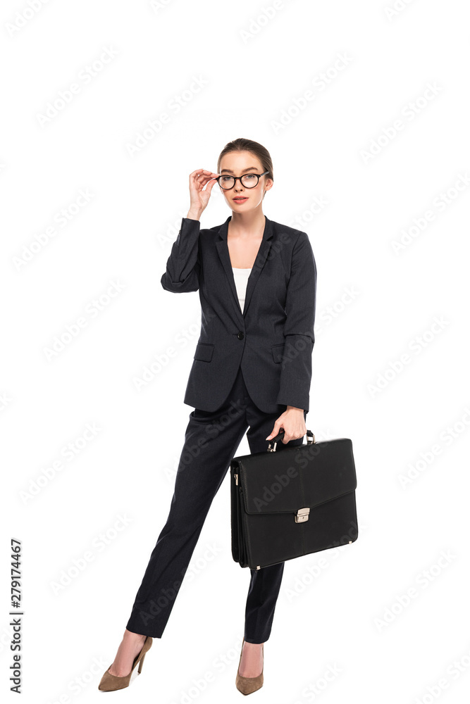 full length view of young successful businesswoman in black suit and glasses with briefcase isolated on white full length view of young successful businesswoman in black suit and glasses with briefcase isolated on white