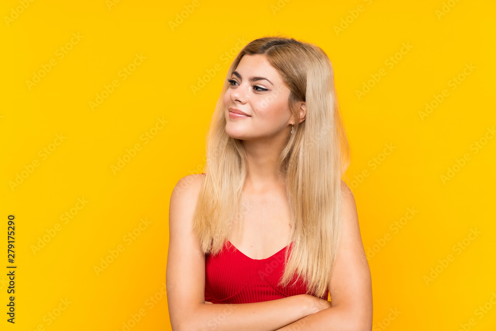 Teenager girl over isolated yellow background laughing Teenager girl over isolated yellow background laughing