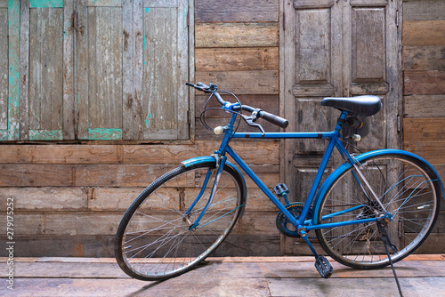 Blue vintage bicycle with wooden wall
