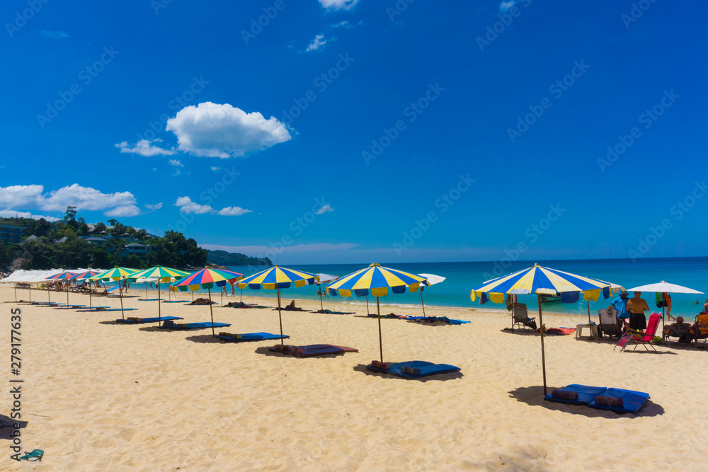 Colorful beach chair with umbrella on white sand beach