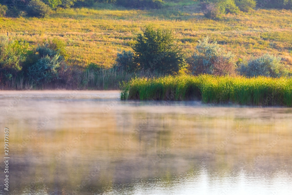 Landscape with misty morning on lake or pond Landscape with misty morning on lake or pond