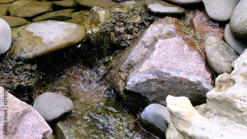 Fragment of a small decorative artificial waterfall in a summer botanical garden, landscape design video clip 4k close-up Fragment of a small decorative artificial waterfall in a summer botanical garden, landscape design video clip 4k close-up
