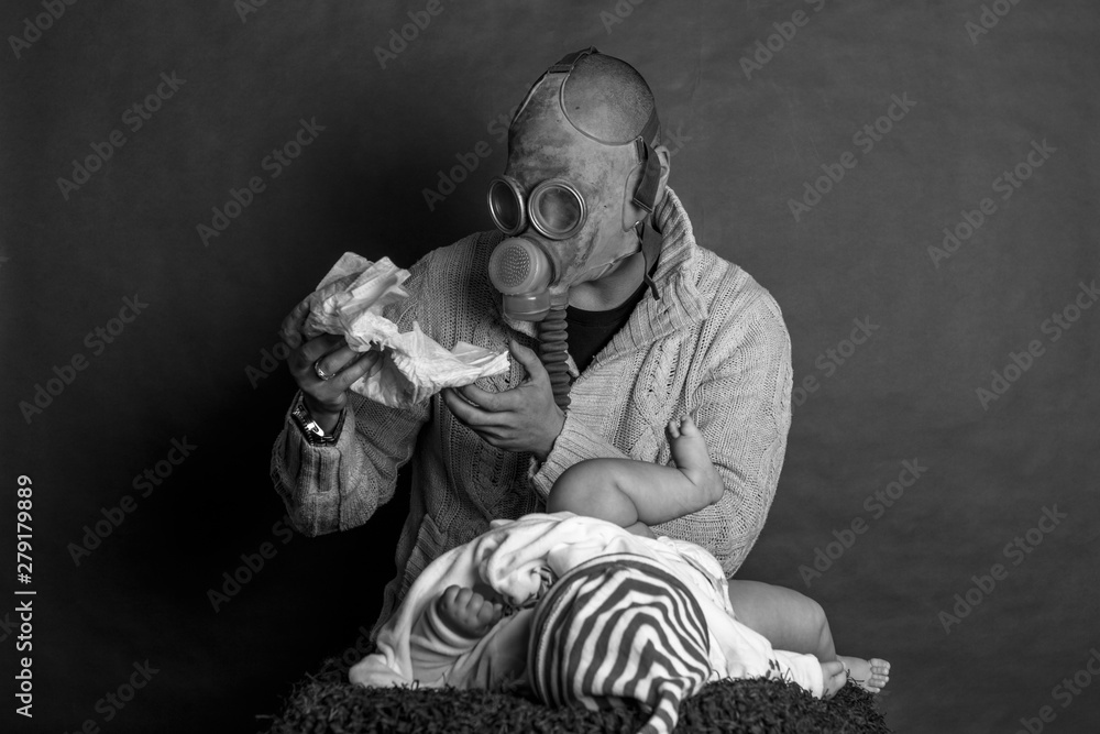 Young Dad cleaning his baby's dirty ass, changing the stinky diaper in