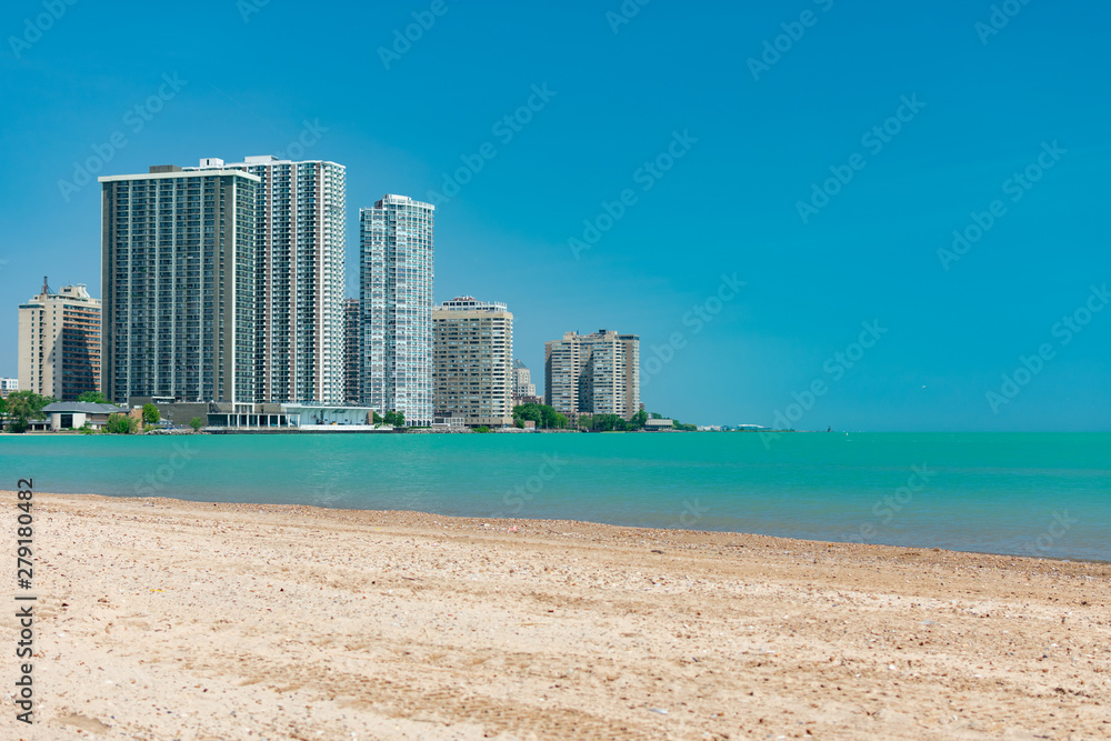 Beach view of the Skyline of Edgewater and Rogers Park with Lake Michigan in Chicago