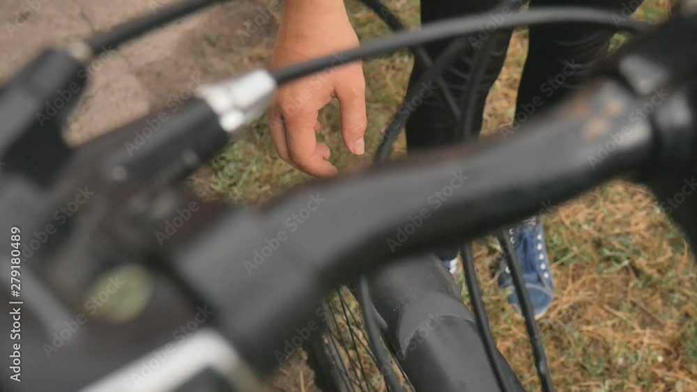 The girl broke the wheel of the bike. Bicycle repair. The cyclist is repairing the bicycle. Hole in the wheel. The girl broke the wheel of the bike. Bicycle repair. The cyclist is repairing the bicycle. Hole in the wheel.