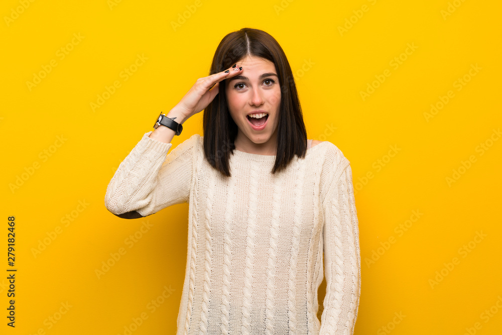 Young woman over isolated yellow wall has just realized something and has intending the solution Young woman over isolated yellow wall has just realized something and has intending the solution
