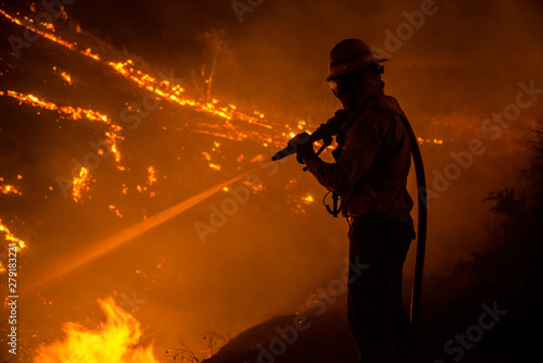 Silhouette of wildland firefighter in action