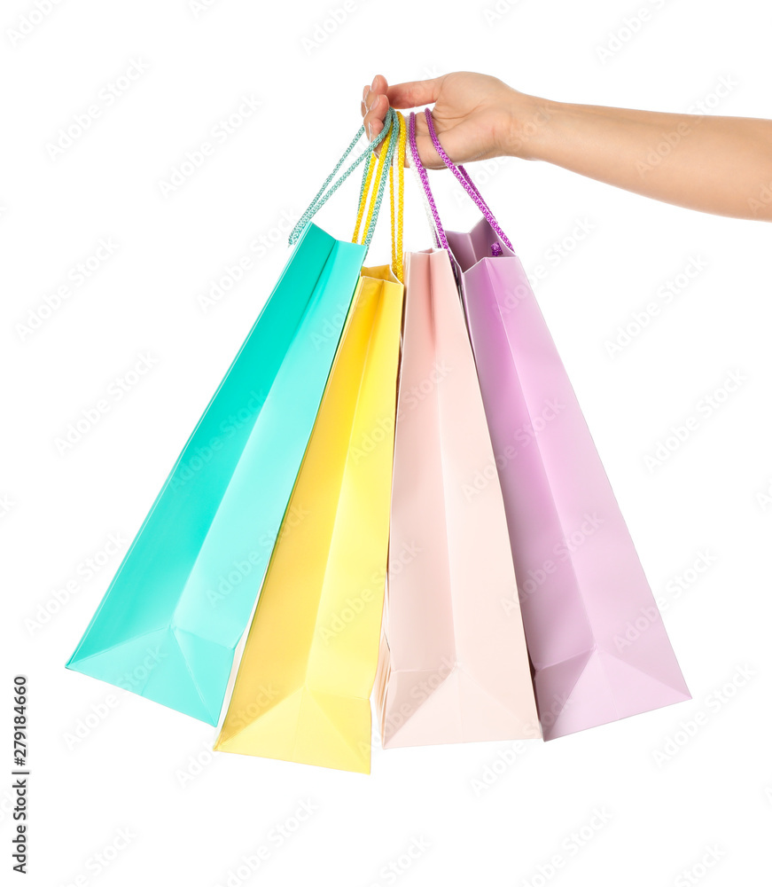 Female hand hold color paper bags isolated on white background