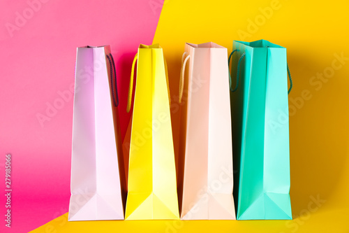 Color paper bags on multicolor background, space for text
