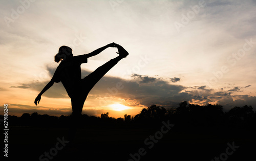 Silhouette of young woman practicing yoga outdoor. Female happiness. Sport and healthy concept. © krisana
