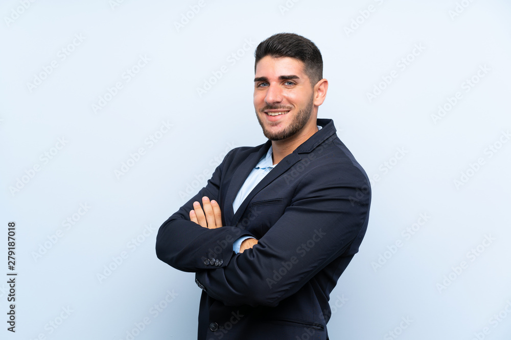 Handsome man over isolated blue background with arms crossed and looking forward Handsome man over isolated blue background with arms crossed and looking forward