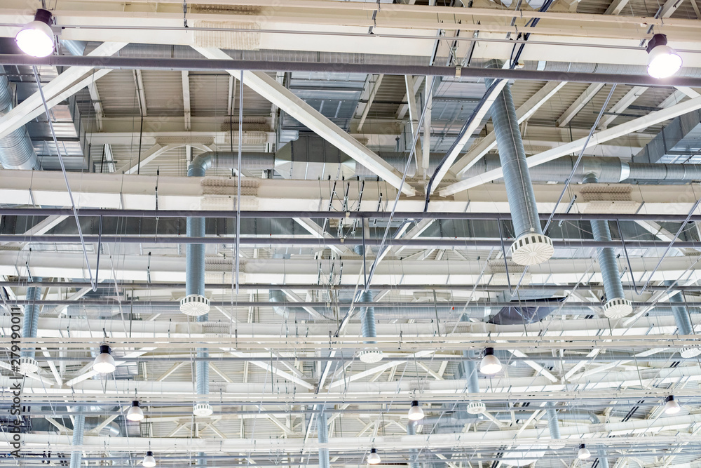Supply and exhaust ventilation system on the ceiling in the exhibition hall. Lighting in the warehouse. Supply and exhaust ventilation system on the ceiling in the exhibition hall. Lighting in the warehouse.