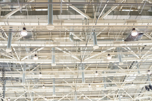 Supply and exhaust ventilation system on the ceiling in the exhibition hall. Lighting in the warehouse.