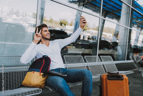 Cheerful guy is taking selfie before trip