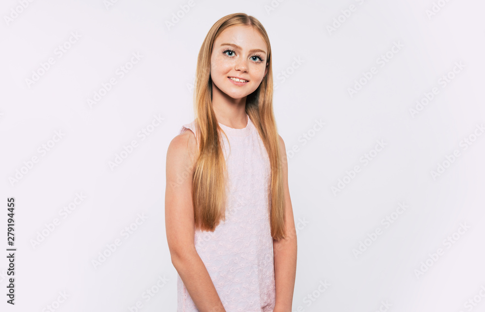 Close up portrait of happy attractive and cute blonde little girl with long hair while she is posing isolated in studio and smiling Close up portrait of happy attractive and cute blonde little girl with long hair while she is posing isolated in studio and smiling