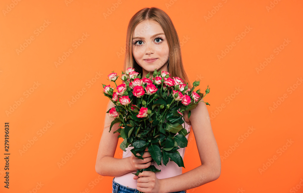 Beautiful, cute, lovely, smiling blonde little girl with happy eyes holds large bouquet of flowers isolated in studio. Birthday, holidays, Valentines day, mothers day concepts.