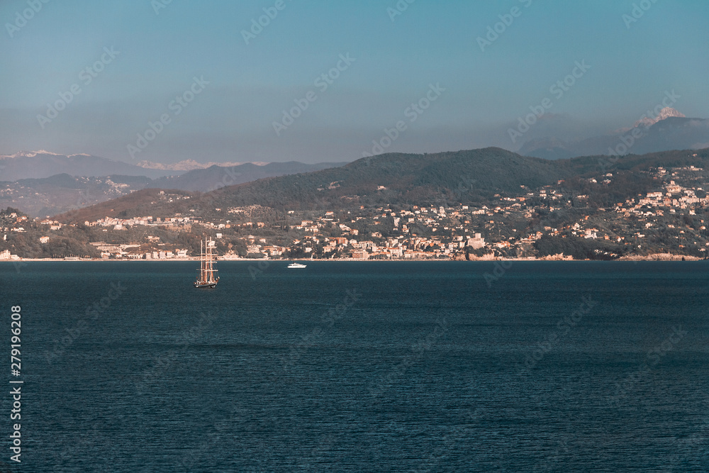 Sailing ship in the Mediterranean in the background of the Alps mountains
