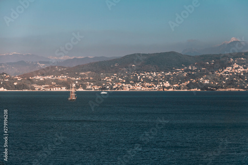 Sailing ship in the Mediterranean in the background of the Alps mountains
