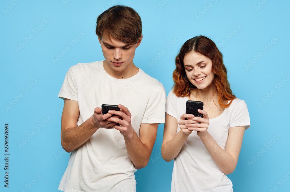 two friends taking picture of themselves with mobile phone two friends taking picture of themselves with mobile phone
