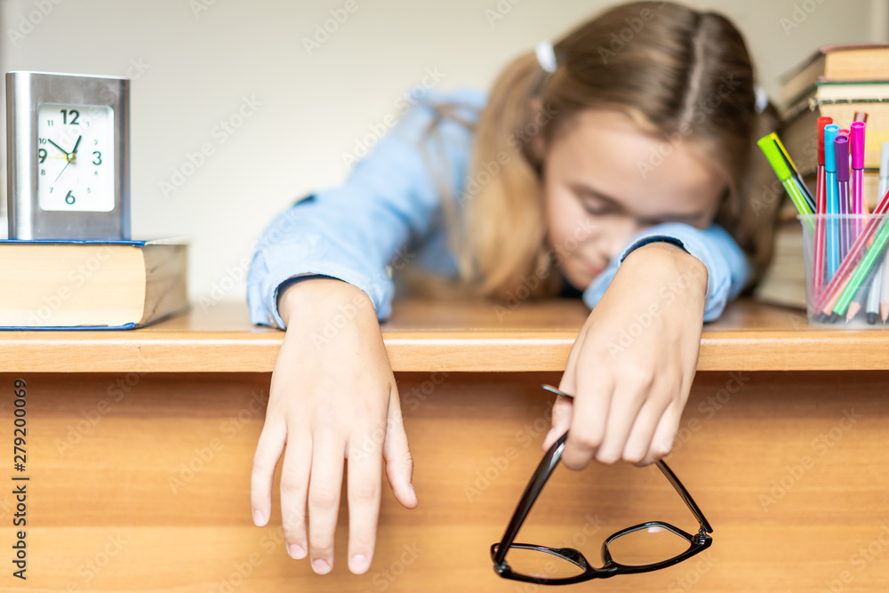 Stressed college student tired of hard learning with books in exams tests preparation, overwhelmed high school teen girl exhausted with difficult studies or too much homework, cram concept Stressed college student tired of hard learning with books in exams tests preparation, overwhelmed high school teen girl exhausted with difficult studies or too much homework, cram concept