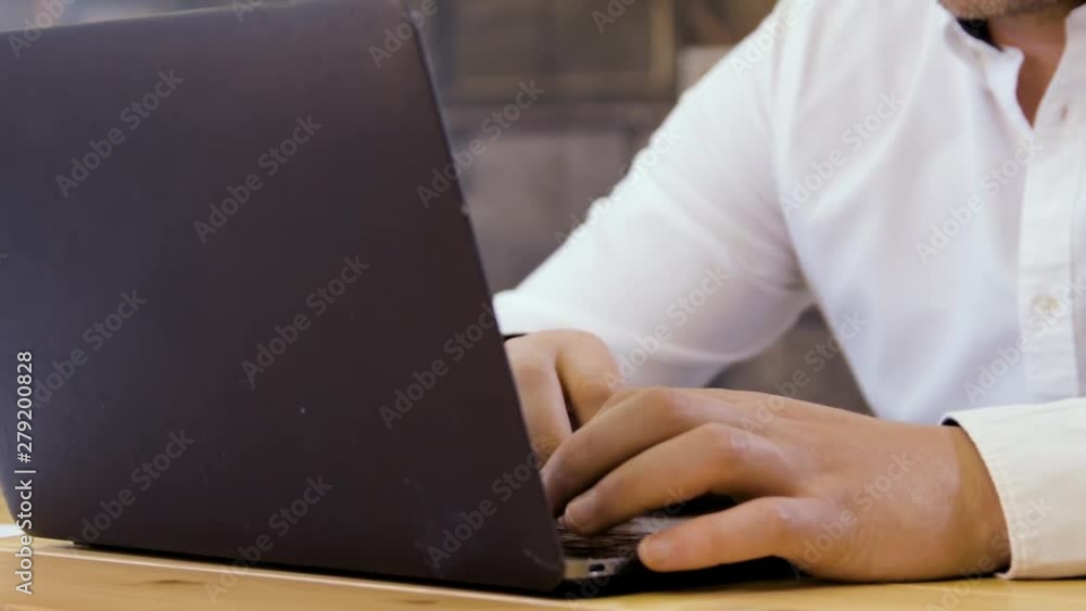 Businessman working on a laptop in small business office for startup team. Businessman working on a laptop in small business office for startup team.