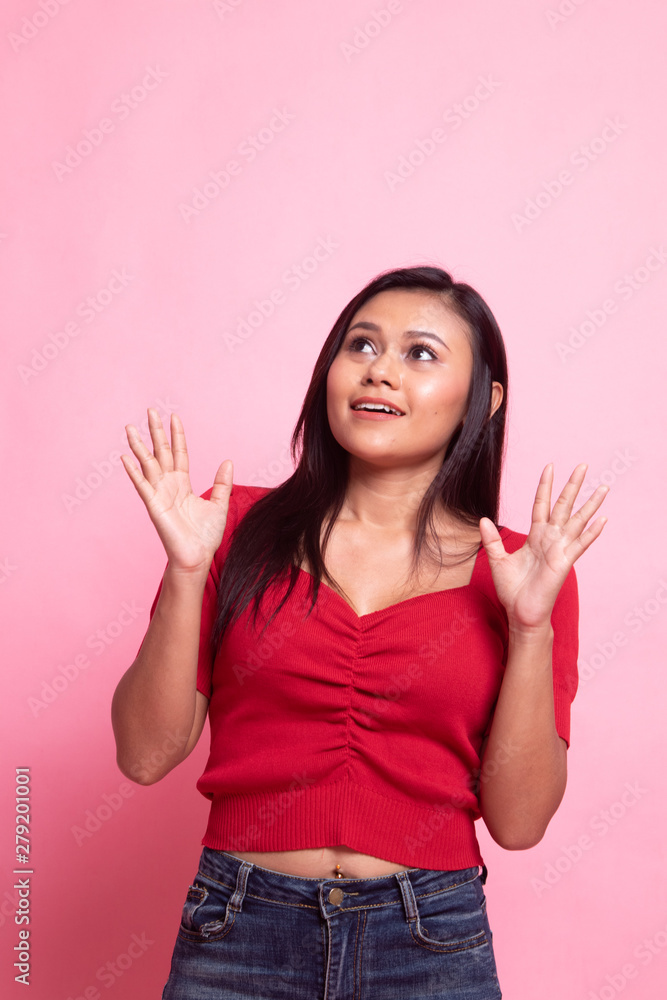 Excited young Asian woman look up. Excited young Asian woman look up.
