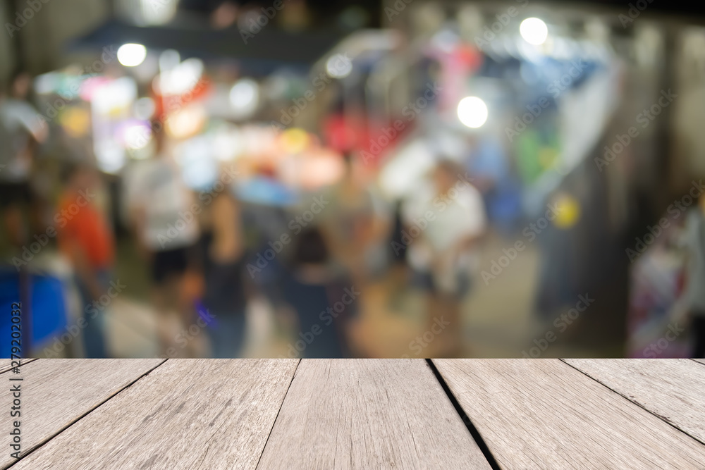 Wooden desk in front blurrrd night market abstract background, presentation and template concept Wooden desk in front blurrrd night market abstract background, presentation and template concept