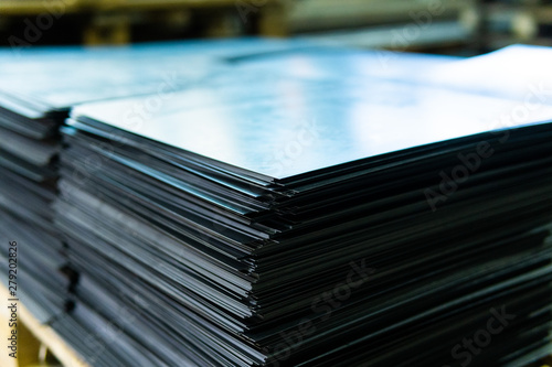 Steel sheets deposited in stacks in packs at the warehouse of metal products. Weathered metals sheet for construction. Metal corrosion