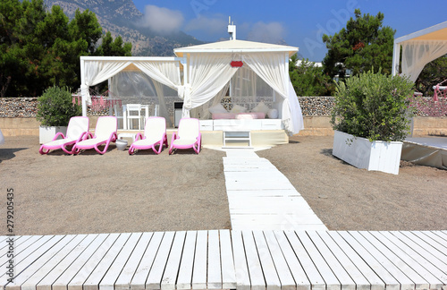 Luxury beach pavilion on the shore of a sandy beach - the Mediterranean coast, Kemer, Antalya, Turkey.