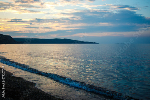 Coastline of the sea in the rays of the setting sun