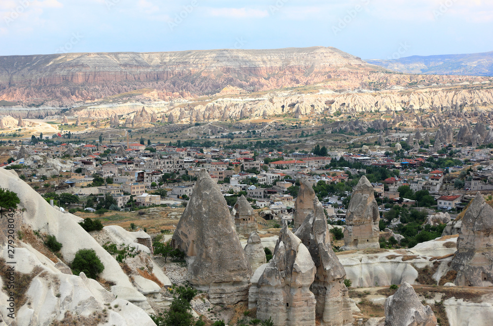 The town Göreme with rock houses in front of the spectacularly coloured valleys nearby. Cappadocia, Central Anatolia, Turkey.
