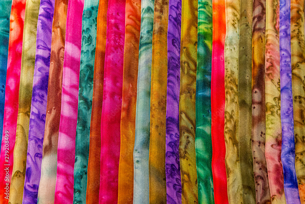 A full frame photograph of a display of colourful material A full frame photograph of a display of colourful material