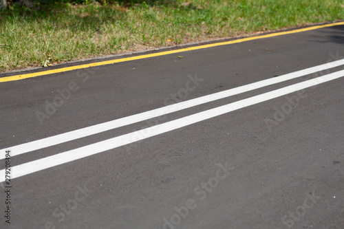 Asphalt road with yellow and white lines background