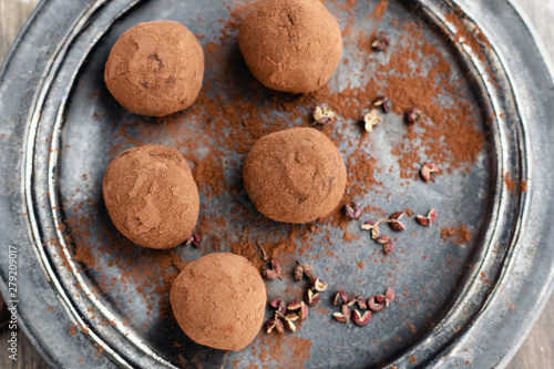 delicious dark chocolate candy truffles with sichuan pepper on dark background, top view