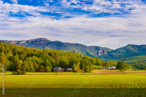 Farm landscape with Mt. Mansfield in the background, Stowe, Vermont, USA photo