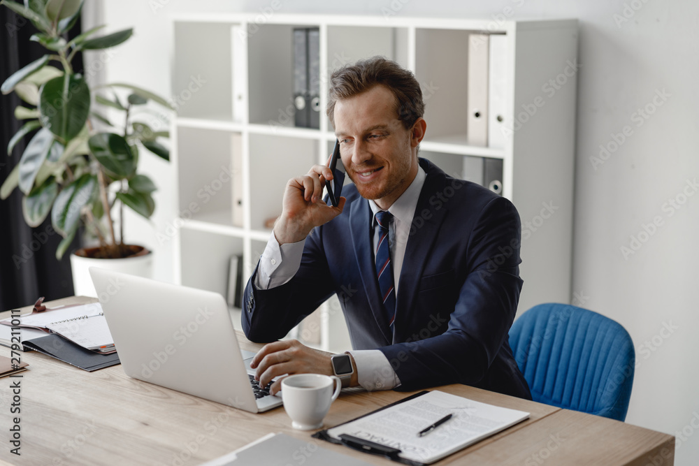 Businessman answering phone call and smiling friendly Businessman answering phone call and smiling friendly