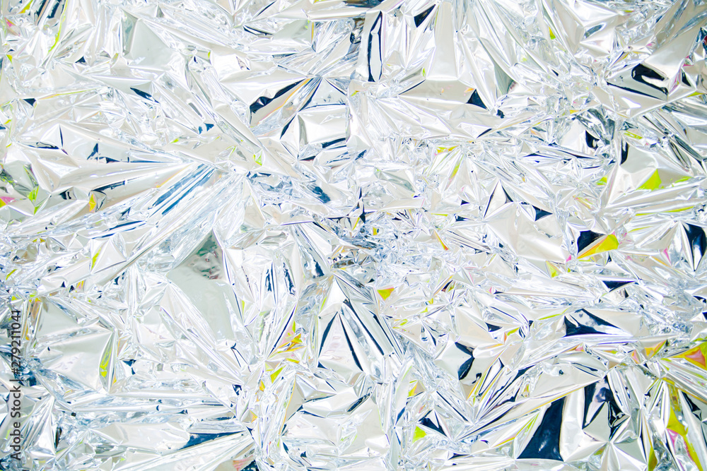 Bright background from metallic foil. Holographic effect. Back in the 80s 90s Bright background from metallic foil. Holographic effect. Back in the 80s 90s