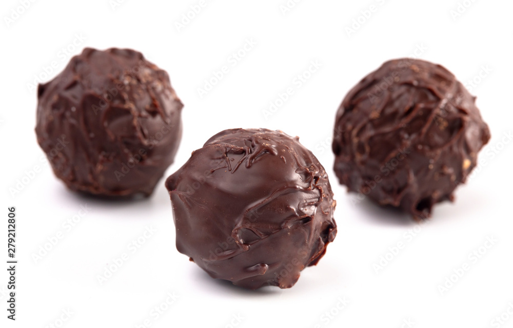 Dark Chocolate Truffles Filled with Caramel on a White Backgroun Dark Chocolate Truffles Filled with Caramel on a White Backgroun