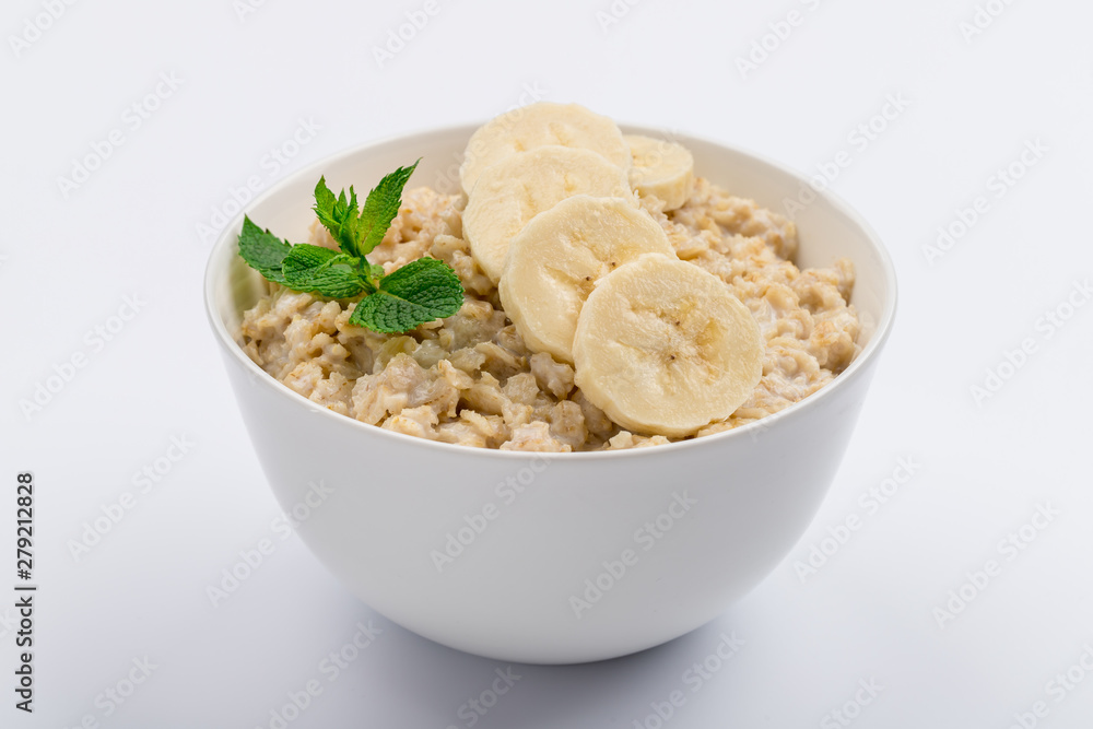 Oatmeal with banana and mint on white, not isolated Oatmeal with banana and mint on white, not isolated