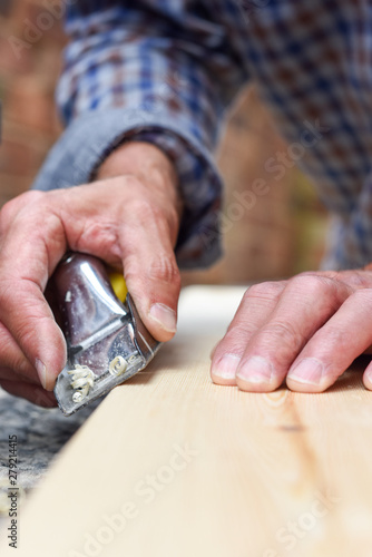  Close up of male hands doing woodwork using tools © tommoh29