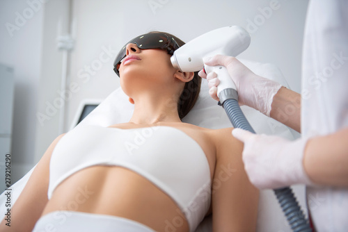 Young lady on face laser epilation procedure
