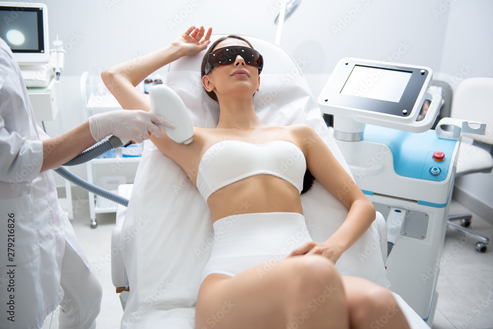 Relaxed lady on armpit laser epilation procedure Relaxed lady on armpit laser epilation procedure