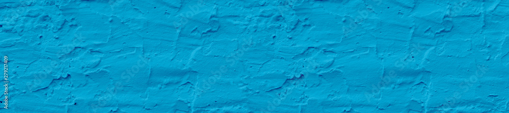 Fototapeta premium Panorama rough light blue color textured wall background.