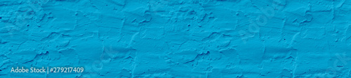 Panorama rough light blue color textured wall background.